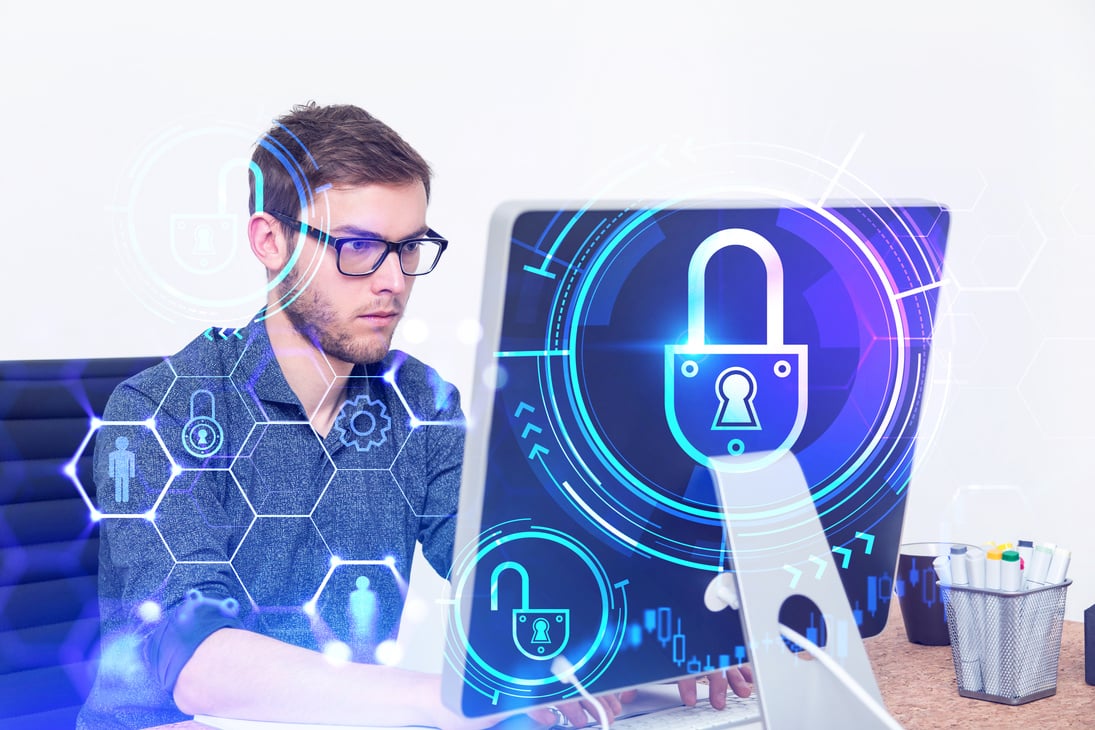 Engineer with computer, cyber security interface